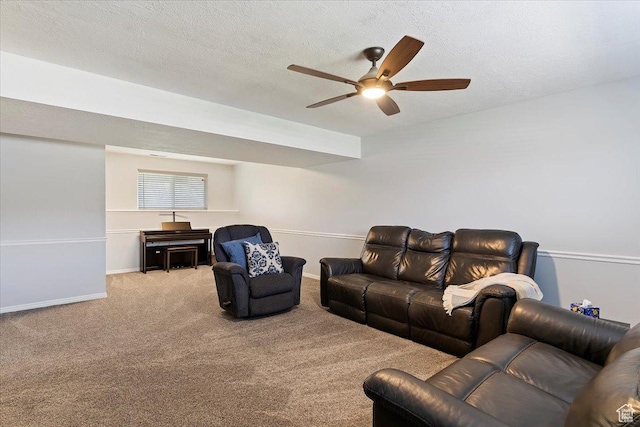 carpeted living room with ceiling fan, baseboards, and a textured ceiling
