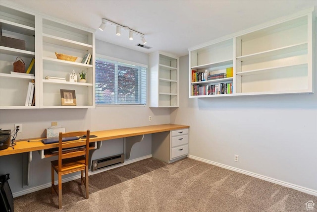 home office with built in study area, rail lighting, visible vents, a baseboard radiator, and carpet flooring
