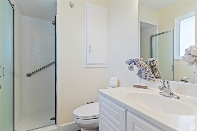 full bath featuring vanity, a shower stall, and toilet