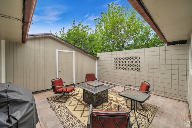 view of patio / terrace featuring a grill and fence