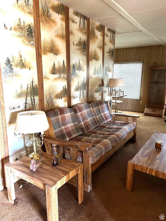 carpeted living area featuring wood walls