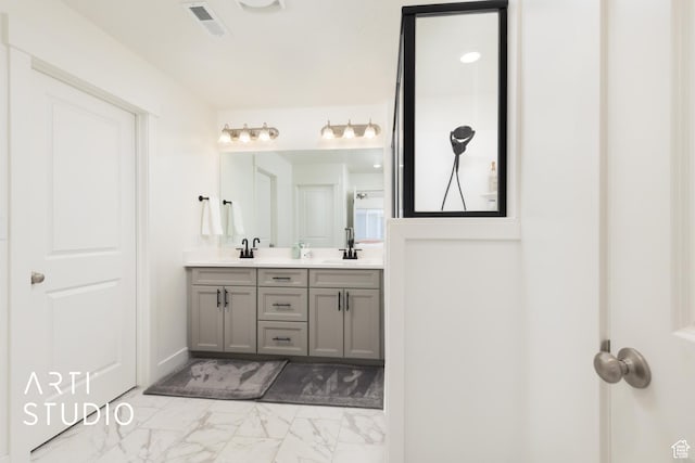 full bathroom featuring double vanity, visible vents, marble finish floor, and a sink