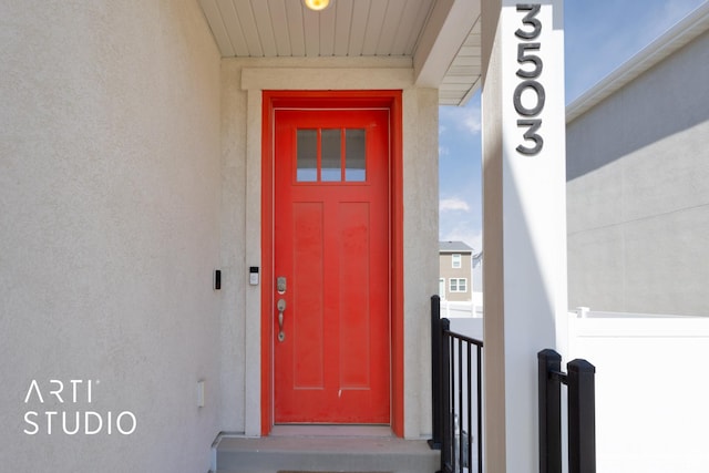 entrance to property with stucco siding
