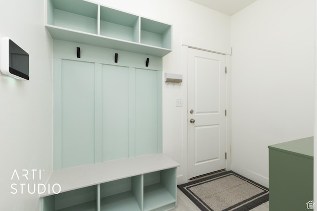 mudroom with wood finished floors and baseboards