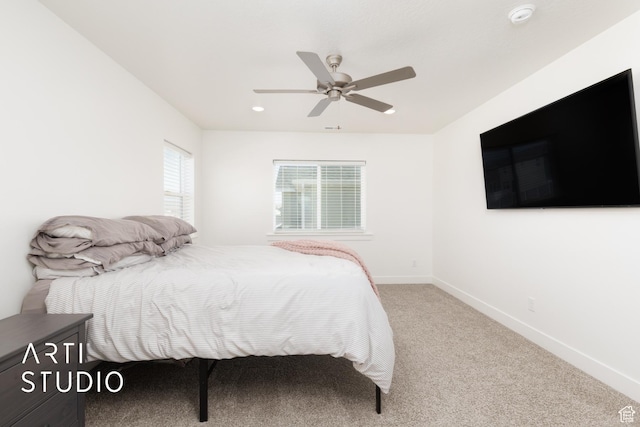 carpeted bedroom with baseboards and ceiling fan