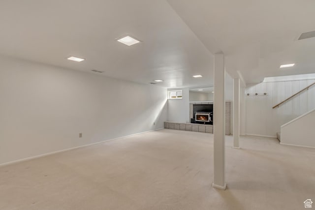 2344 E Arnett Dr, Millcreek, UT 84109 - below grade area featuring light carpet, baseboards, a brick fireplace, and stairway