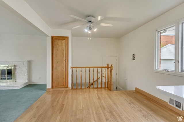 2344 E Arnett Dr, Millcreek, UT 84109 - interior space with a glass covered fireplace, visible vents, light wood finished floors, and ceiling fan