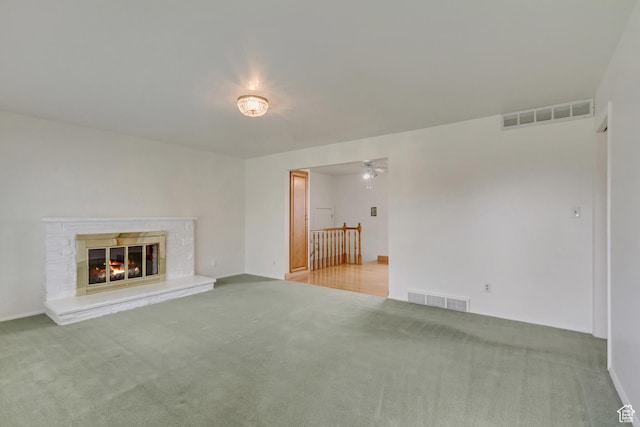 2344 E Arnett Dr, Millcreek, UT 84109 - unfurnished living room with ceiling fan, carpet flooring, visible vents, and a fireplace