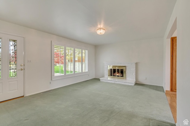 2344 E Arnett Dr, Millcreek, UT 84109 - unfurnished living room featuring a healthy amount of sunlight, visible vents, and carpet