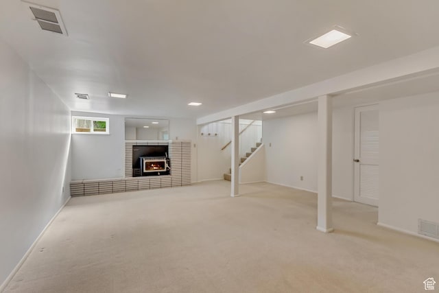 2344 E Arnett Dr, Millcreek, UT 84109 - basement featuring carpet, a brick fireplace, stairway, and visible vents