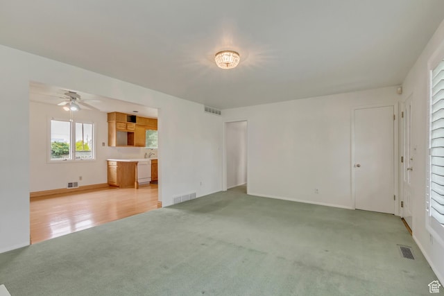 2344 E Arnett Dr, Millcreek, UT 84109 - unfurnished living room with light carpet, a ceiling fan, and visible vents