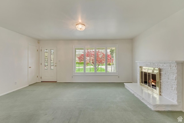 2344 E Arnett Dr, Millcreek, UT 84109 - unfurnished living room featuring baseboards, a glass covered fireplace, and carpet flooring