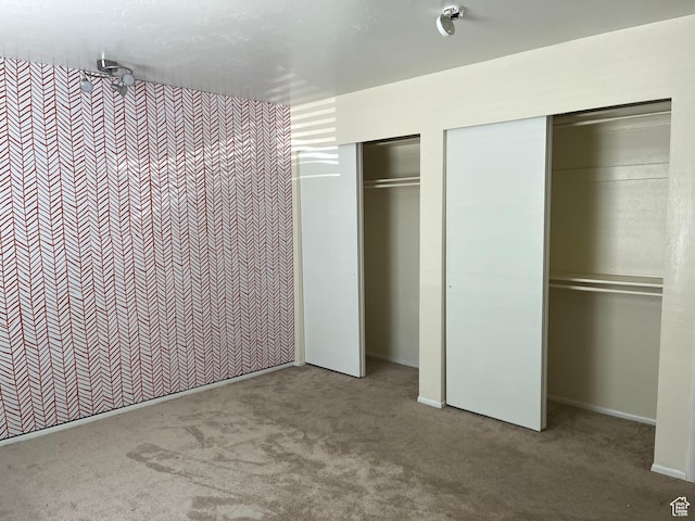 416 E Creekside Cir Unit C, Murray, UT 84107 - unfurnished bedroom with baseboards, carpet, and multiple closets