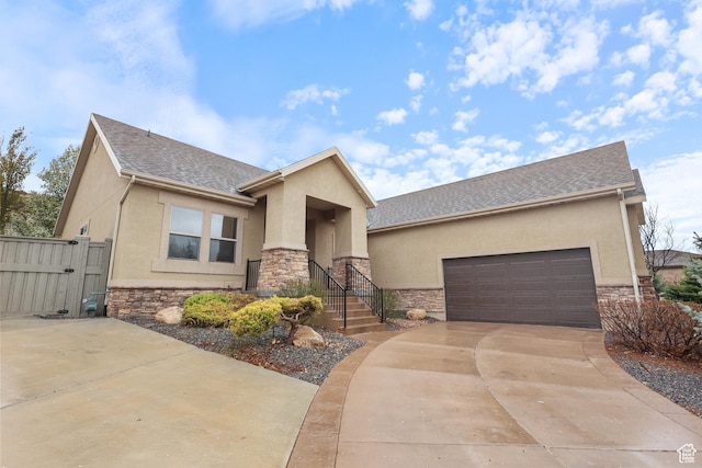 9226 N Mount Airey Dr W, Eagle Mountain, UT 84005 - view of front of house with stone siding, stucco siding, a gate, concrete driveway, and a garage