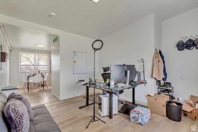 office with baseboards, visible vents, and light wood finished floors