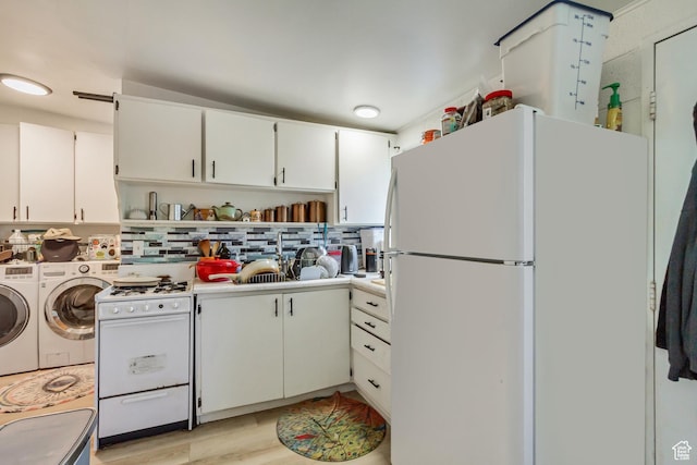 kitchen with open shelves, washer and clothes dryer, white cabinets, white appliances, and backsplash