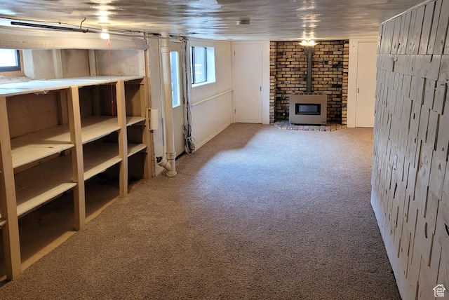 273 S 7th St S, Montpelier, ID 83254 - below grade area featuring carpet, heating unit, and a wood stove