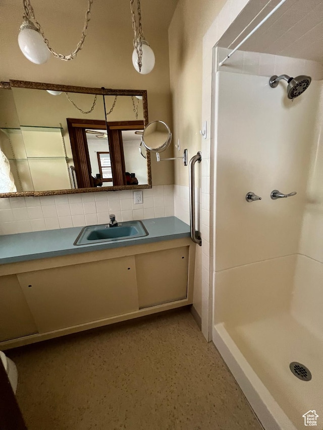 273 S 7th St S, Montpelier, ID 83254 - full bath featuring a stall shower, vanity, and tile walls