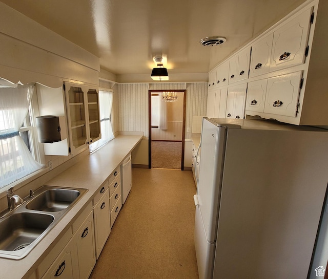 273 S 7th St S, Montpelier, ID 83254 - kitchen featuring white appliances, white cabinets, a chandelier, and light countertops