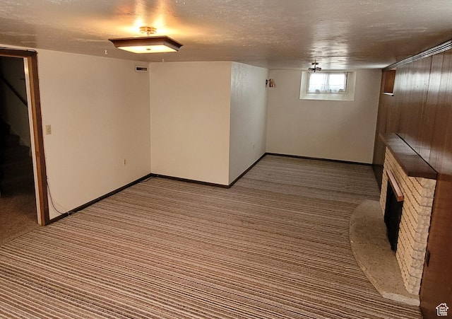 273 S 7th St S, Montpelier, ID 83254 - below grade area with carpet floors, stairs, a fireplace, and a textured ceiling