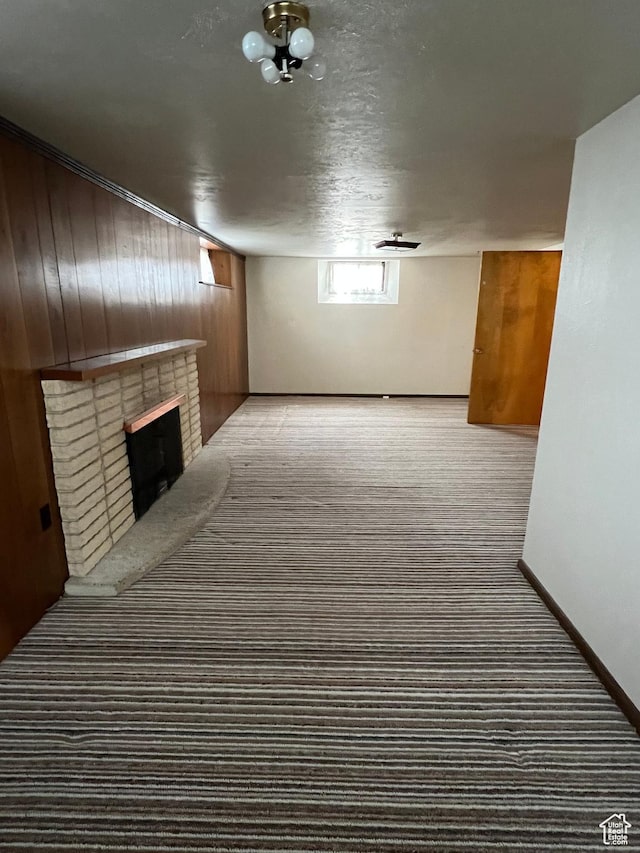273 S 7th St S, Montpelier, ID 83254 - basement with carpet floors, wood walls, a brick fireplace, and baseboards