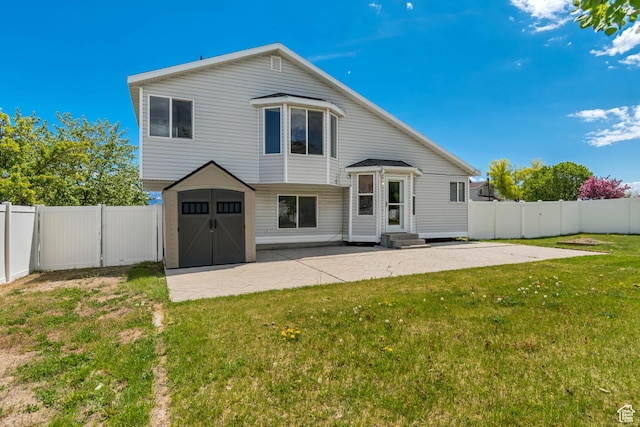 6706 S Adventure Way, West Jordan, UT 84084 - back of property with entry steps, a patio, a shed, and a lawn