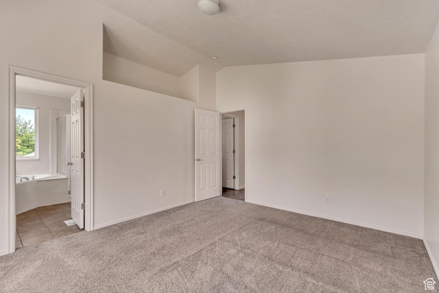 6706 S Adventure Way, West Jordan, UT 84084 - unfurnished bedroom featuring baseboards, ensuite bathroom, carpet flooring, and vaulted ceiling