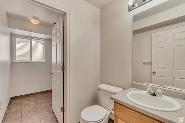 6706 S Adventure Way, West Jordan, UT 84084 - bathroom with toilet, baseboards, vanity, and tile patterned flooring