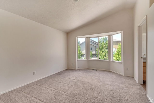 6706 S Adventure Way, West Jordan, UT 84084 - spare room featuring carpet, a textured ceiling, visible vents, baseboards, and vaulted ceiling