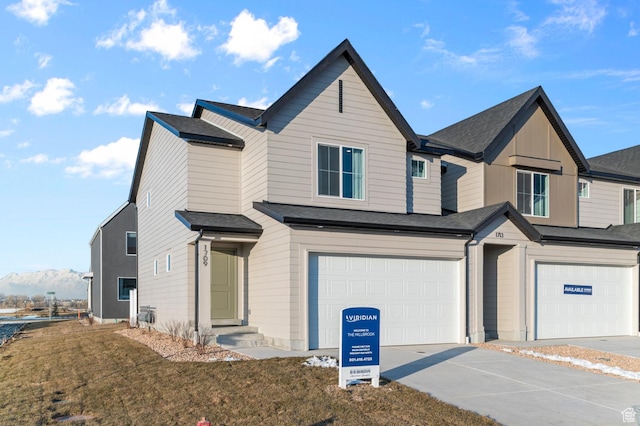 view of front of home featuring an attached garage, a front lawn, and concrete driveway