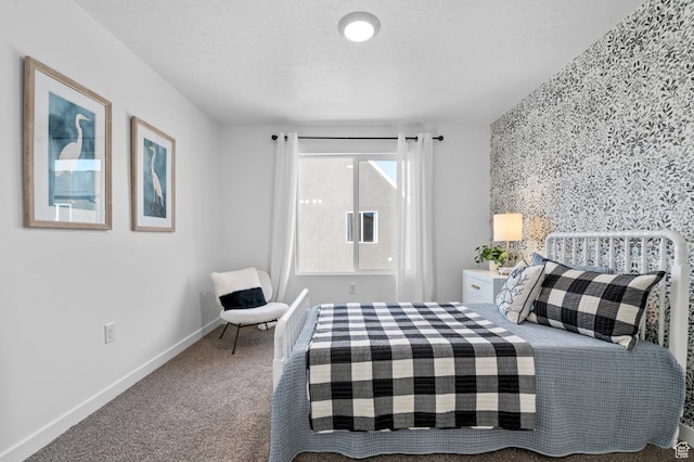 carpeted bedroom featuring baseboards
