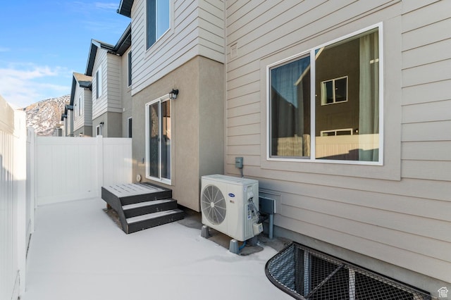 exterior space with fence, ac unit, and a mountain view