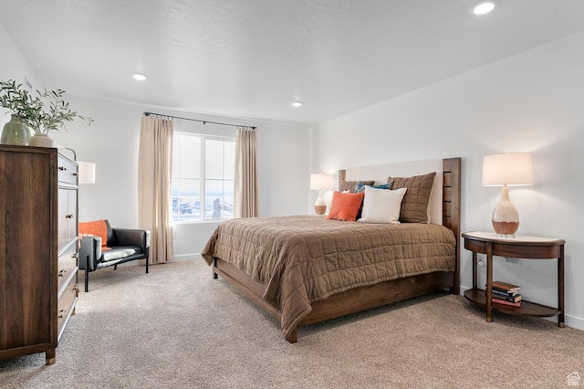 bedroom featuring baseboards, light carpet, and recessed lighting