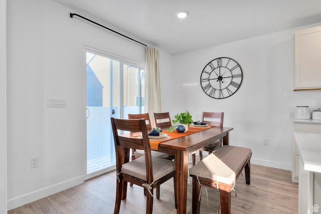 dining space featuring recessed lighting, baseboards, and light wood-type flooring