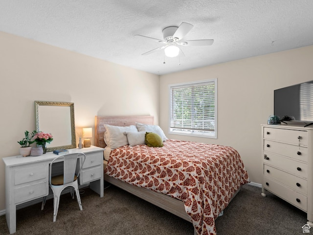 bedroom featuring dark carpet, a textured ceiling, and ceiling fan