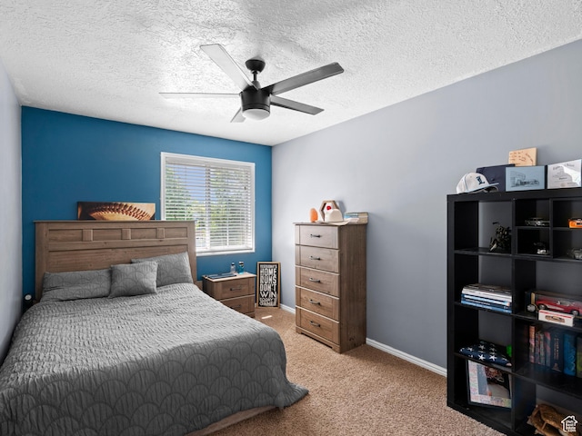 carpeted bedroom featuring baseboards, a textured ceiling, and ceiling fan