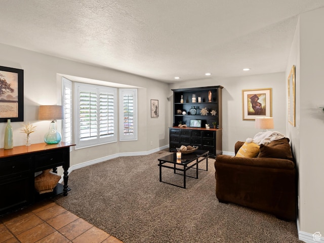 carpeted living area featuring baseboards, a textured ceiling, and recessed lighting
