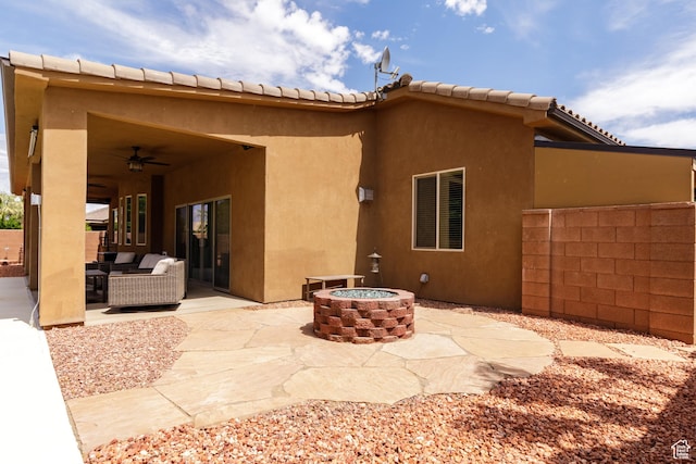 2562 S 4010 W, Hurricane, UT 84737 - rear view of property featuring stucco siding, a patio area, an outdoor living space with a fire pit, and ceiling fan