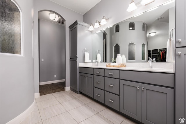 2562 S 4010 W, Hurricane, UT 84737 - full bathroom with tile patterned floors, double vanity, a sink, a walk in closet, and baseboards