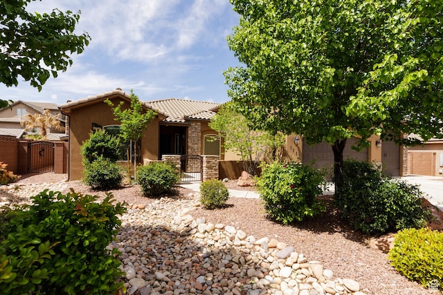 2562 S 4010 W, Hurricane, UT 84737 - view of front facade with a gate, fence private yard, a tiled roof, and stucco siding