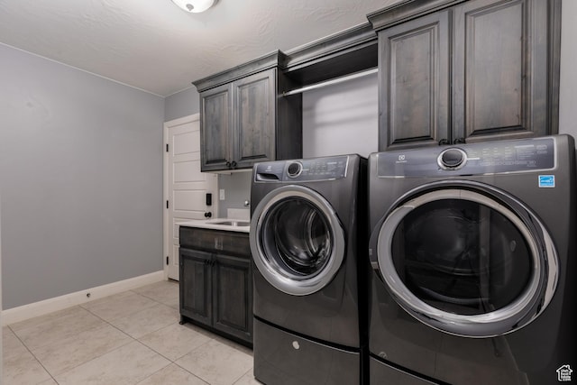 2562 S 4010 W, Hurricane, UT 84737 - clothes washing area featuring cabinet space, washing machine and clothes dryer, baseboards, and light tile patterned flooring