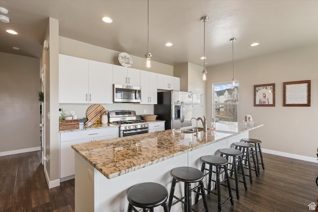 111 S 1800 W, Pleasant Grove, UT 84062 - kitchen with a large island with sink, a sink, dark wood finished floors, baseboards, and appliances with stainless steel finishes
