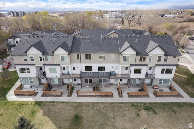 111 S 1800 W, Pleasant Grove, UT 84062 - rear view of property featuring stone siding, a residential view, a patio, roof with shingles, and a standing seam roof