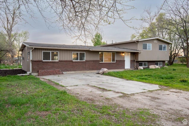 2389 S 4300 W, Taylor, UT 84401 - split level home with brick siding, board and batten siding, a front yard, and concrete driveway