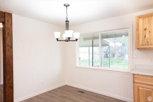 2389 S 4300 W, Taylor, UT 84401 - unfurnished dining area with baseboards, a notable chandelier, wood finished floors, and visible vents