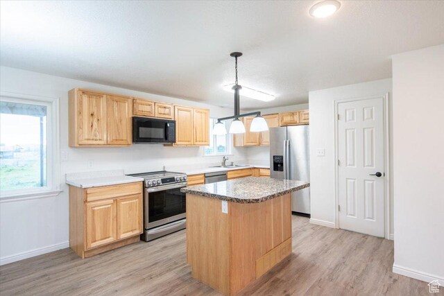2389 S 4300 W, Taylor, UT 84401 - kitchen with light brown cabinets, a center island, light wood-type flooring, a sink, and stainless steel appliances