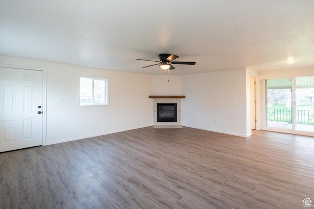 2389 S 4300 W, Taylor, UT 84401 - unfurnished living room featuring baseboards, plenty of natural light, a ceiling fan, and wood finished floors