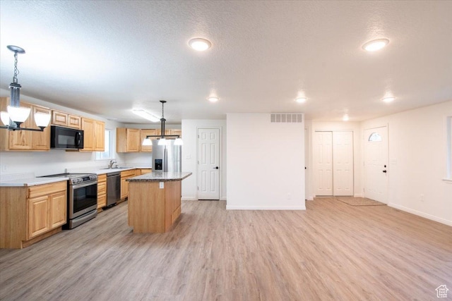 2389 S 4300 W, Taylor, UT 84401 - kitchen with a kitchen island, stainless steel appliances, a sink, and light wood-type flooring