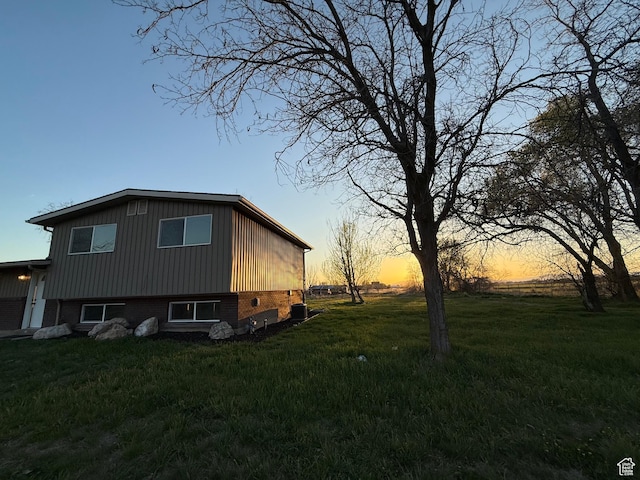view of side of property featuring a lawn
