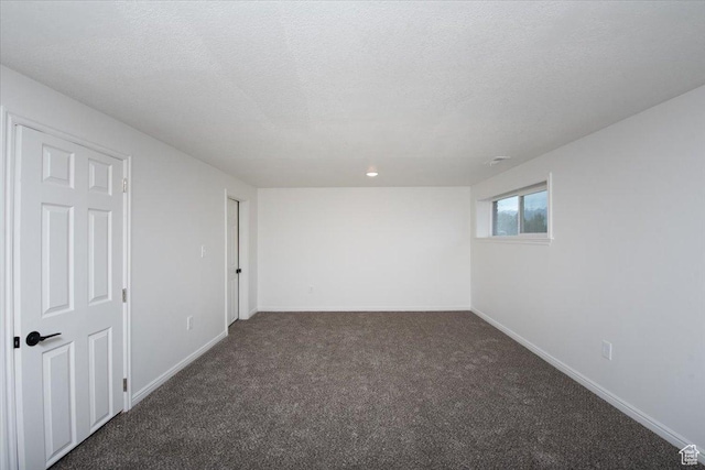 2389 S 4300 W, Taylor, UT 84401 - spare room with a textured ceiling, baseboards, and dark colored carpet